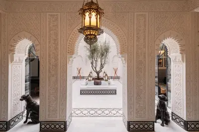 a room with a chandelier and a statue of dogs at Riad Kheirredine in Marrakech