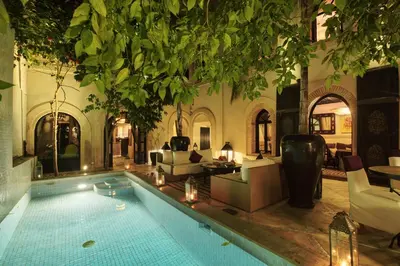 a house with a swimming pool in a living room at Riad Kheirredine in Marrakech