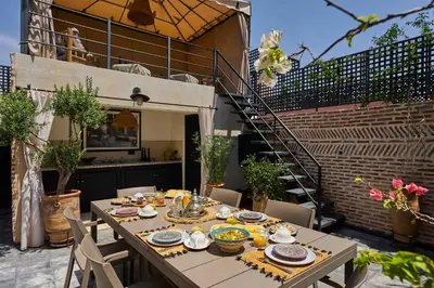a table with plates of food on a patio at Riad Miloud en exclusivité 10 P au cœur de la Médina in Marrakech