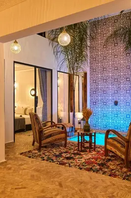 a living room with two chairs and a table at Riad Miloud en exclusivité 10 P au cœur de la Médina in Marrakech