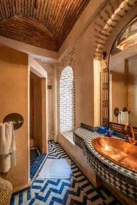 a bathroom with a large tub and a window at Riad Adilah Marrakech - by EMERALD STAY in Marrakech