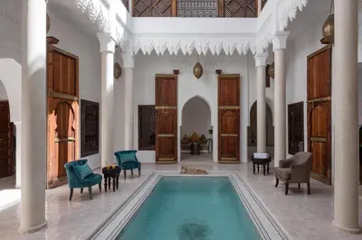a large room with a swimming pool in a house at Riad Spice by Marrakech Riad in Marrakech