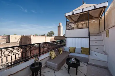 a balcony with a couch and a table on a building at Riad Spice by Marrakech Riad in Marrakech