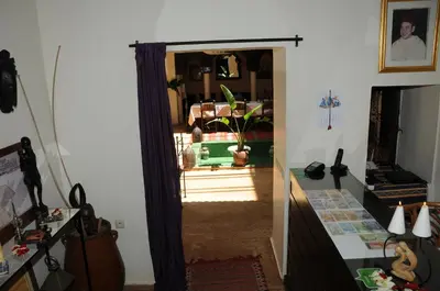 a hallway with a door open to a living room at Riad Haraka in Marrakech