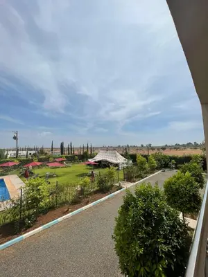 a view of a garden from a window at Palais Benfatah in Marrakech