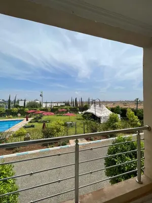 a view of a park from a balcony at Palais Benfatah in Marrakech