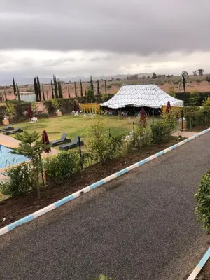 a view of a garden with a house and a road at Palais Benfatah in Marrakech