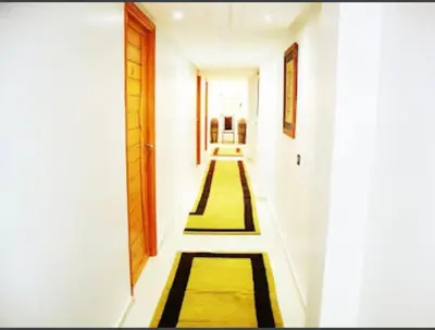 a hallway with yellow and black rugs in a building at Palais Benfatah in Marrakech