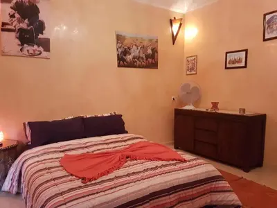 a bedroom with a bed and a wooden dresser at Zaitouna, Quiet apartment, Modern in Marrakech