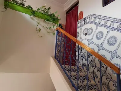 a staircase with a wrought iron railing in a house at Zaitouna, Quiet apartment, Modern in Marrakech