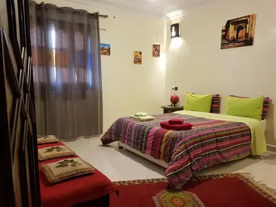 a bedroom with two beds and a window at Zwina Appart, A Small, Cozy Family Nest in Marrakech