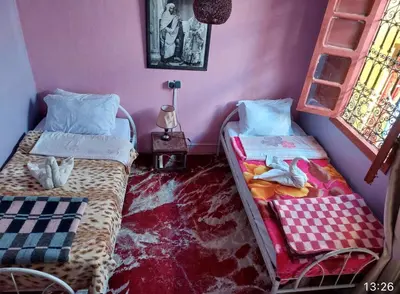 two beds in a room with pink walls at Hostel Marrakech Rouge in Marrakech