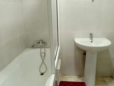 a bathroom with a sink and a shower and a toilet at Appartement rouge 6 perso in Marrakech