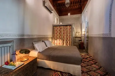 a bedroom with a bed and a table in a room at Riad 72 in Marrakech