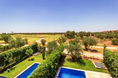 an aerial view of a garden with two swimming pools at VILLA Waky & Golf - Jardin de l'Atlas in Marrakech