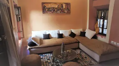 a living room with a couch and a table at Riad Alqimam in Marrakech