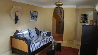 a living room with a couch in a room at Riad Alqimam in Marrakech
