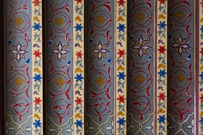 a wallpaper with red and blue designs on a wall at RIAD AZRUR in Marrakech
