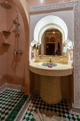 a bathroom with a sink and a mirror at Riad Medina Art & Suites in Marrakech