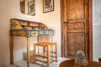 a wooden table with a stool next to a door at Medina Sun in Marrakech
