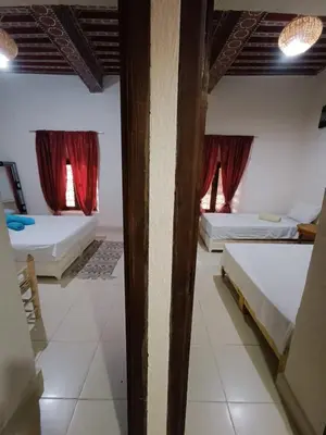 a room with two beds and two windows at Terrace House in Marrakech