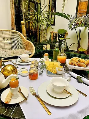 a table with plates and bowls of food on it at Riad Dar Yasaman in Marrakech