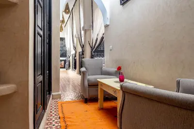 a hallway with chairs and a table in a building at RIAD LA GAZELLE DU SUD in Marrakech