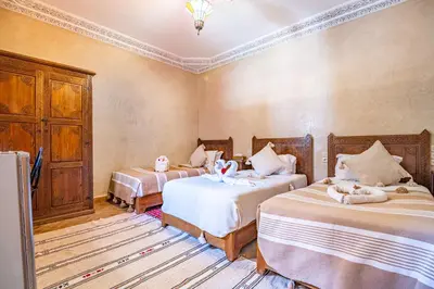 a bedroom with two beds with cats sitting on them at RIAD VILLA SIDI BABA in Marrakech