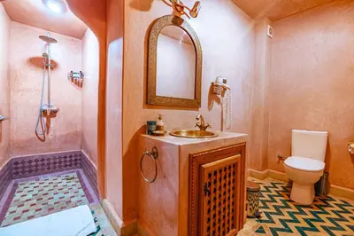 a bathroom with a sink and a toilet and a mirror at RIAD VILLA SIDI BABA in Marrakech