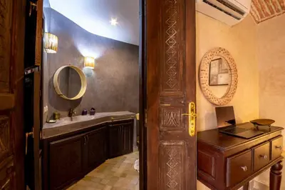 a bathroom with a sink and a mirror at Riad 7 Saints in Marrakech