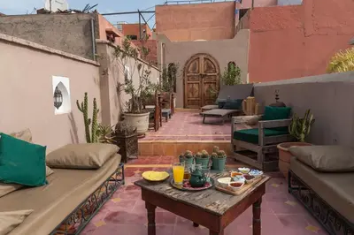 a patio with a table with food on it at Riad La Clé de la Medina, location en exclusivité de tout le riad in Marrakech