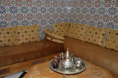 a living room with couches and a table at Riad BAB ALMADINA in Marrakech