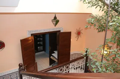 a staircase leading to a room with a mirror at Riad BAB ALMADINA in Marrakech