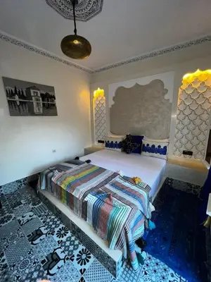 a bedroom with a bed in a room at Dar KHALID in Marrakech