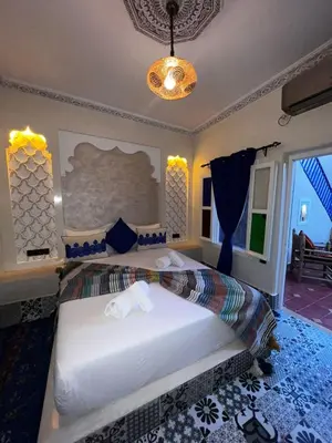 a bedroom with a large bed in a room at Dar KHALID in Marrakech