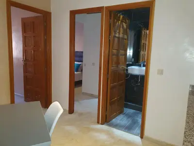 a room with a mirror and a kitchen with a sink at Charming Marrakech Apartement in Marrakech