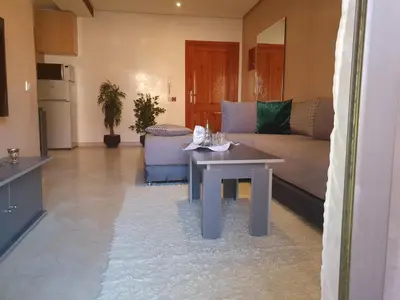 a living room with a couch and a table at Charming Marrakech Apartement in Marrakech