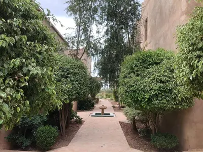 a garden with a fire hydrant in the middle of a path at Villa Mayrit, Villa estilo Riad en un entorno único in Marrakech