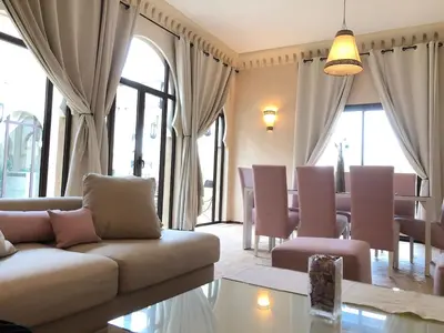 a living room with a couch and a table at Villa Mayrit, Villa estilo Riad en un entorno único in Marrakech