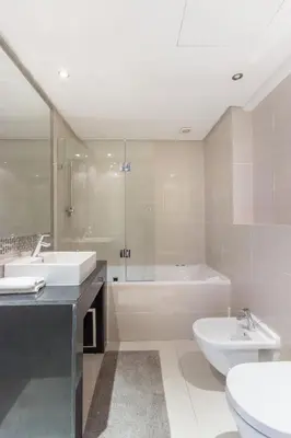 a bathroom with two sinks and a tub and a toilet at Pool View With Garden in Prestigia - WIFI & Pool in Marrakech