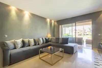 a living room with a couch and a table at Pool View With Garden in Prestigia - WIFI & Pool in Marrakech