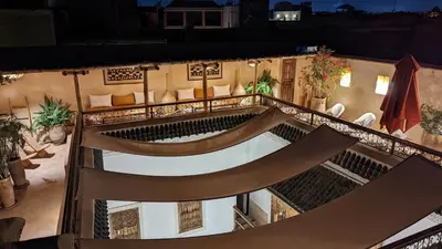 an outdoor patio with a hammock on a building at night at Riad Dar Eternity in Marrakech