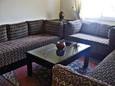 a living room with two couches and a coffee table at Appartement Aïda in Marrakech
