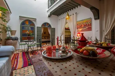 a living room with a table with fruits on it at Riad dar El Arsa Rooftop & jacuzzi in Marrakech