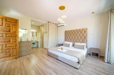 a bedroom with a large bed and a bathroom at Villa White High-Standing - Breakfast in Marrakech