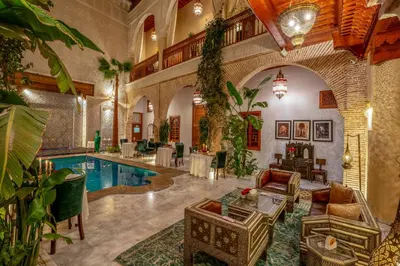 a large living room with a pool in a building at Riad Janate & SPA in Marrakech