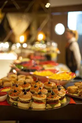 a buffet of pizzas and pastries on a table at Hôtel Ibn Batouta in Marrakech