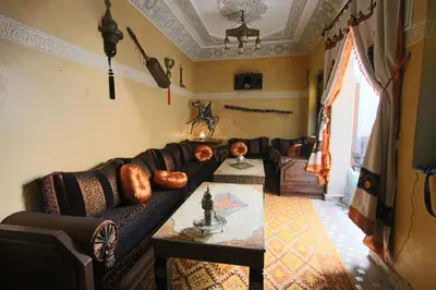 a living room with a couch and a table at RIAD MAKENE MOUCHKILL in Marrakech