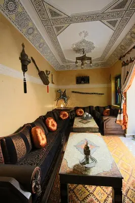 a living room with a couch and a table at RIAD MAKENE MOUCHKILL in Marrakech