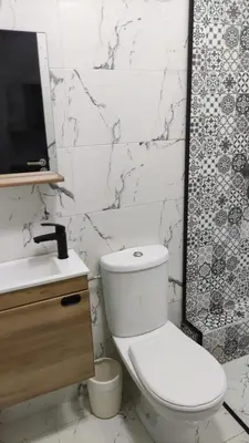 a white bathroom with a toilet and a sink at Appart Kech Village in Marrakech